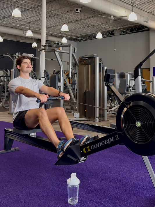 Coach Luke on the rowing machine to keep heart rate in zone 2