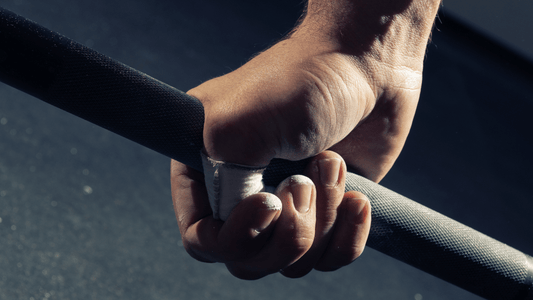 hand holding on to a barbell