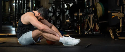 man sitting with tight muscles